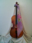 Violoncello with floral scarf draped facing right side.