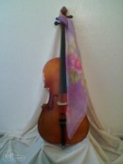 cello with floral scarf draped facing right side.