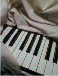 Fabric draped over Piano black and white keys