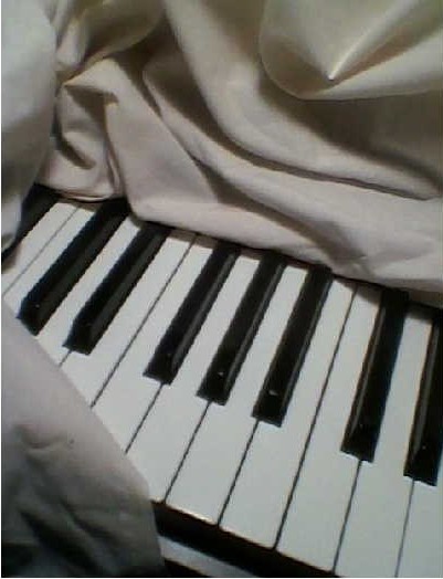 Fabric draped over Piano black and white keys